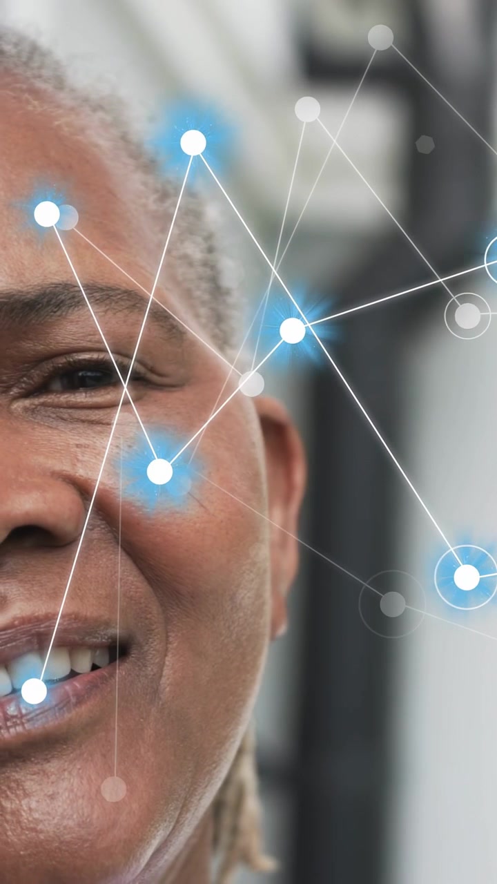 Vertical video: Senior woman smiling and turning with camera pan, blue nodes mapping face for tech
