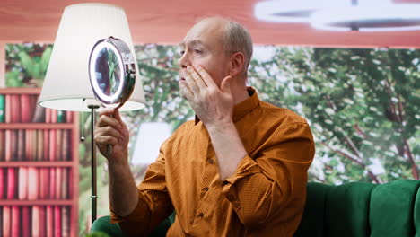 elderly person using mirror to apply grooming skincare products on aging face