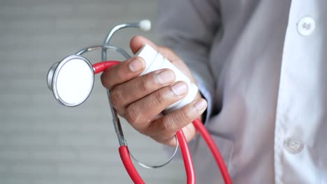 doctor holding stethoscope and medicine