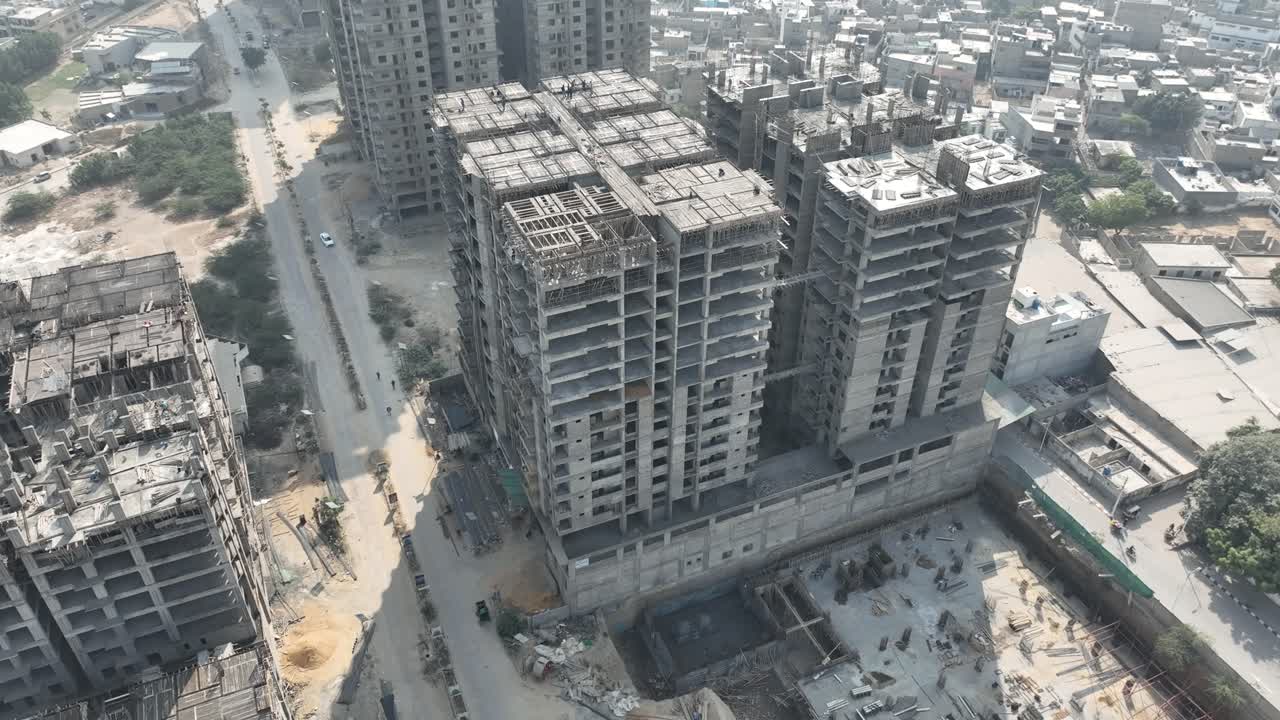 Aerial view of concrete high rise buildings under construction in Karachi, Pakistan, showing ongoing development