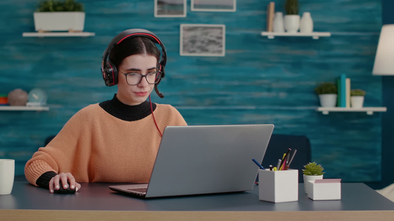 Young person talking on online videoconference with headphones
