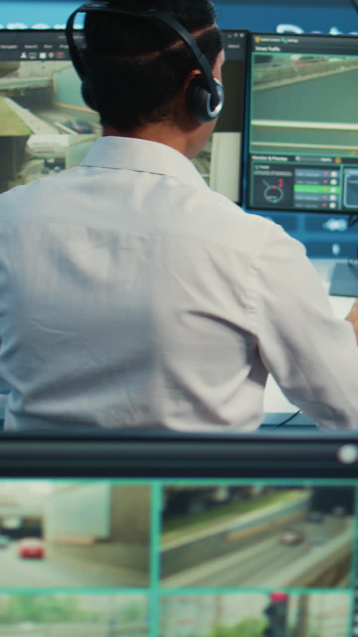Man in Control Room Monitoring City Traffic on Computer Screens
