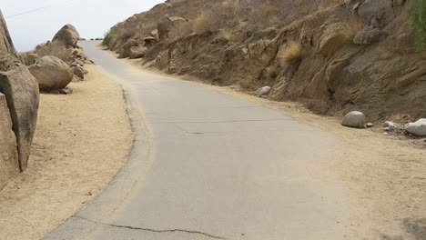 reveal shot of hiking road between rocks in mountains southern california