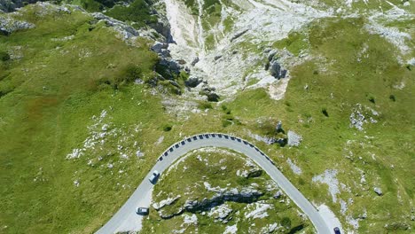 car driving a alpine street in slovenia top down view drone