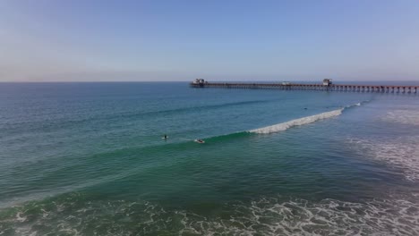 surfers riding waves at oceanside beach, ca