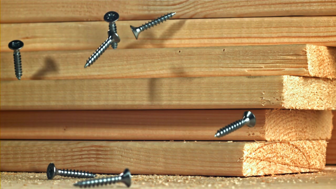 Screws Falling in Slow Motion onto Wooden Planks