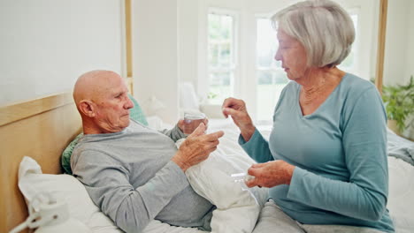 Pills,-senior-couple-and-water-in-a-bed-with-love