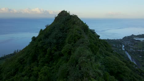 teahupoo tahiti mountain peaks valley hills jungle sunrise yellow clouds golden hour sunset aerial drone view from french polynesia wsl surfing summer olympic venue town village reef forward up down