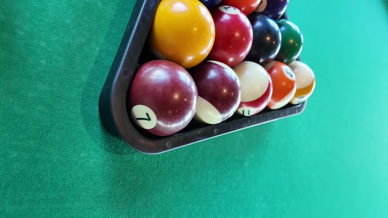 Pool balls in a triangle on a pool table