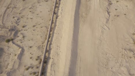 Long-oil-pipeline-in-the-desert-reveal-aerial-footage