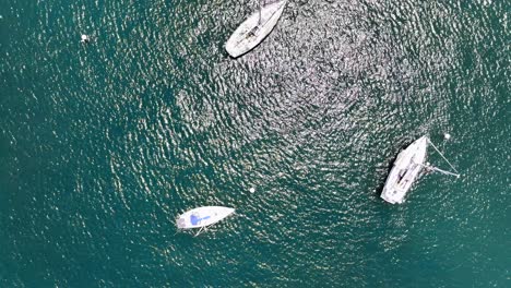 Top down aerial view of sailboats Mooring in turquoise water