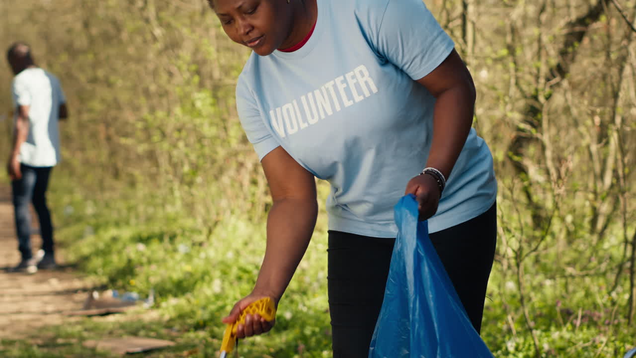 African american activist doing litter cleanup to fight illegal dumping