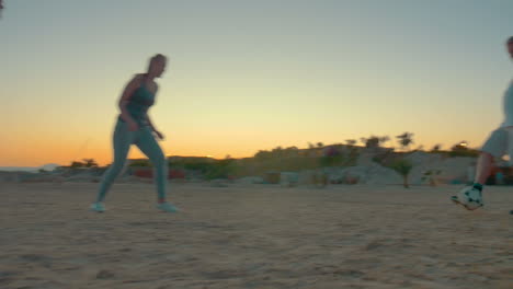 People-having-fun-during-football-playing-on-the-beach