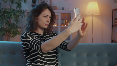 woman taking a selfie on a couch