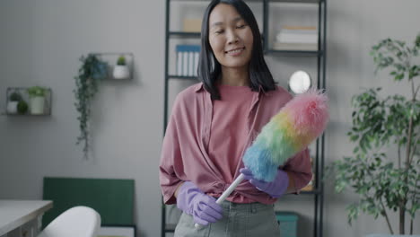 woman cleaning with a colorful duster