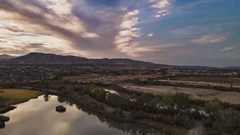 aerial boomerang looping hyperlapse of a idyllic community in a valley below the mountains