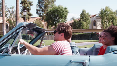 Young-adult-friends-on-the-road-in-a-convertible,-close-up