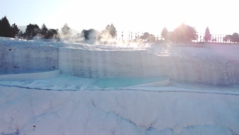 Steamy-blue-hot-springs,-mineral-waters,-forming-travertine-limestone-mineral-deposit-formations