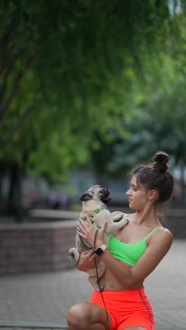 woman with pug in park