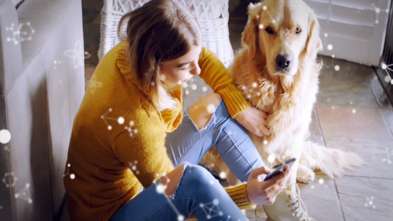 Woman holding smartphone and dog sitting indoors, using technology concept with floating lights