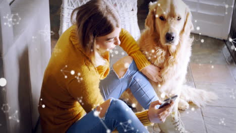 woman holding smartphone and dog sitting indoors, using technology concept with floating lights