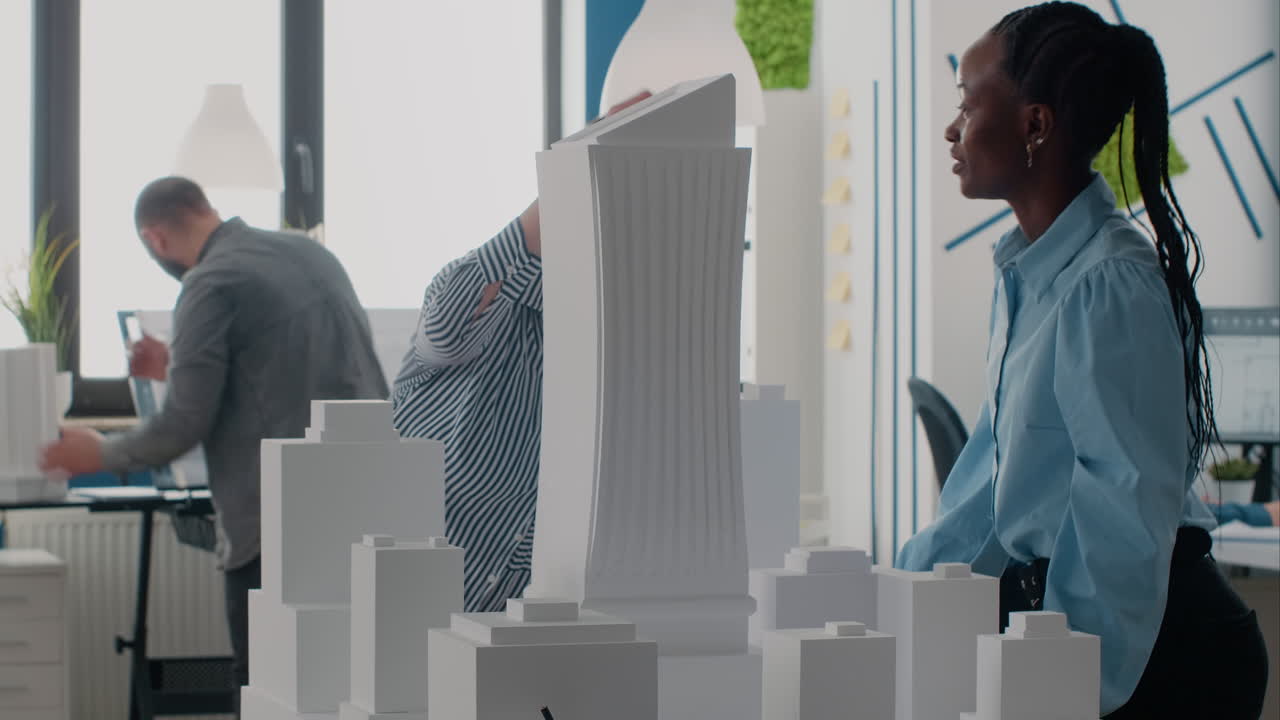 Architects collaborating on a building model in the office