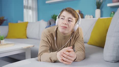 young man listening to emotional music is sad.