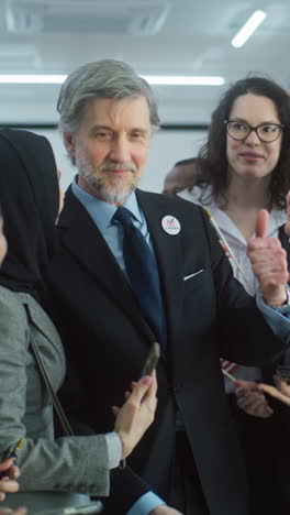 Multiethnic-US-citizens-come-to-female-presidential-candidate-after-voting.-People-take-photos-and-talk-with-American-politician-at-polling-station.-Election-Day-in-the-United-States.-Slow-motion.