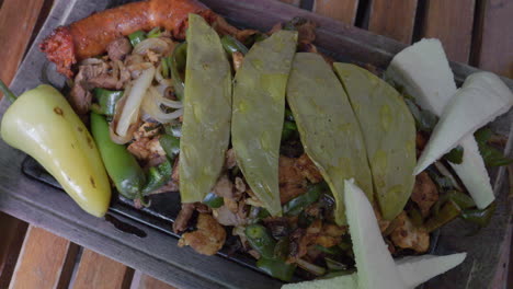 Mexican-platter-cooked-meat,-vegetables-topped-with-nopal-cactus-and-cheese