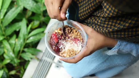 women holding a bowl of breakfast cereal on table