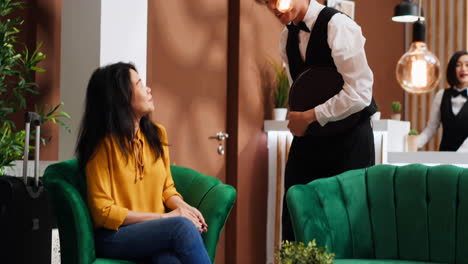 woman paying coffee cup at pos terminal in lounge area