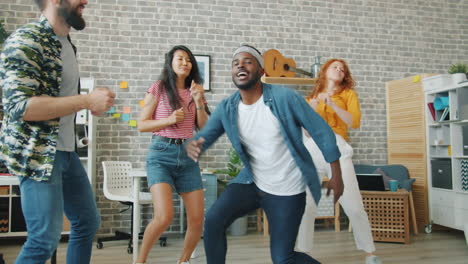 friends dancing in an office