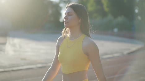 female athlete running on outdoor track in sportswear