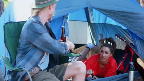 Couple-toasting-beer-in-the-tent-4k