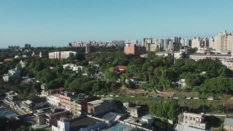 historic tamsui customs officers' residence amidst greenery, under clear blue skies, aerial view