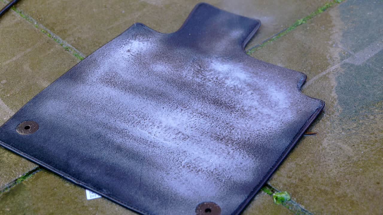 Applying cleaner to small carpet foot with a blue pressure sprayer - close up