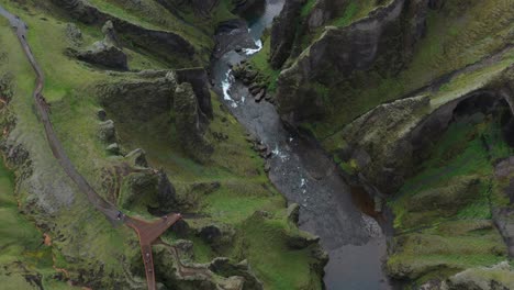 aerial view of icelandic canyon with river and hiking trails