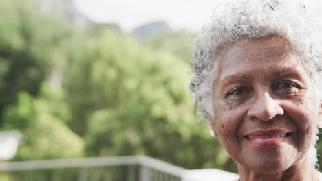 Portrait-of-happy-senior-african-american-woman-smiling-in-garden,-copy-space,-slow-motion