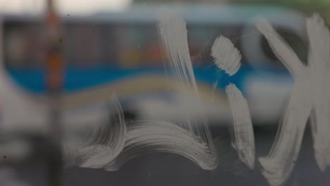 Urban slow motion shot of a street trough the glass of a farmers market in Castro, Chilo&eacute; Chile