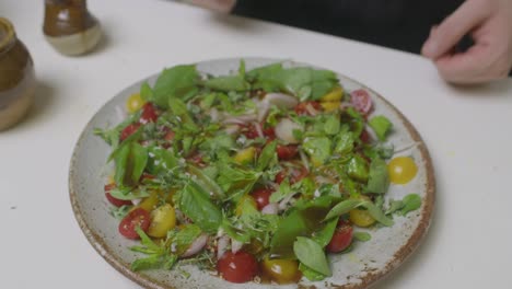 Adding-social-sauce-onto-the-vegetable-herbs-salad