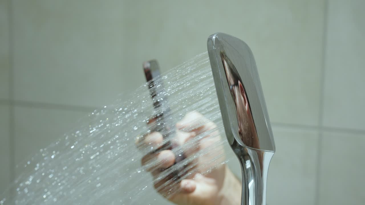 A person using a smartphone while showering, illustrating smartphone and TikTok addiction in everyday life
