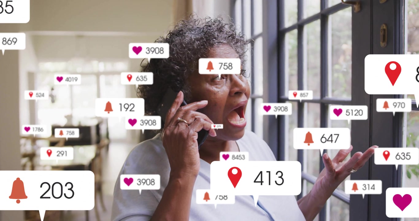 Senior woman holding smartphone and doing social media marketing indoors, with floating alert icons