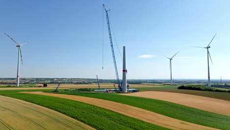 crane next to erected wind turbine tower at the wind farm