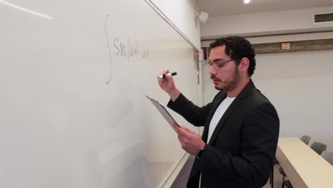 educator demonstrating a concept on a whiteboard