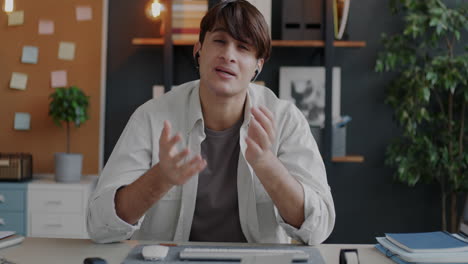 man having a video call in his home office