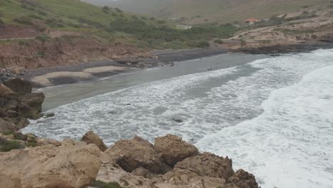 Aerial-static-shot-over-Porto-dos-Frades-with-rough-sea,-Porto-Santo-island