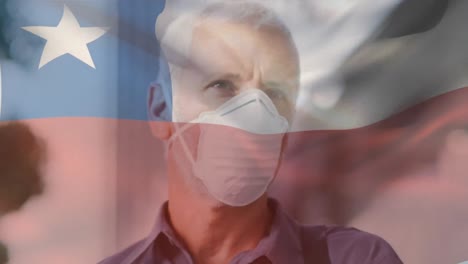 animation of flag of chile waving over man wearing face mask during covid 19 pandemic