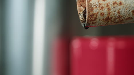 rusty pipe leaking dark liquid