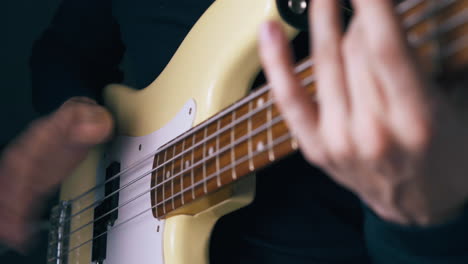 person beats metal bass strings before using slap technique