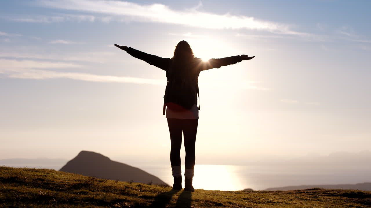 una mujer caminando al atardecer.